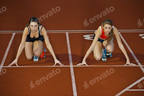Preview: 2 female athletes in starting blocks