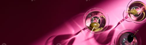 Preview: Top view of martini cocktails on bright pink background with shadows, panoramic shot
