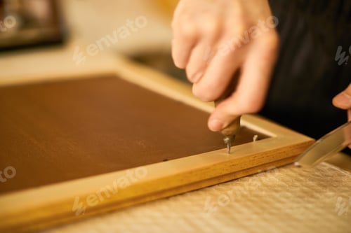 Preview: Man Assembling Wooden Frame Using Hand Tools Indoors