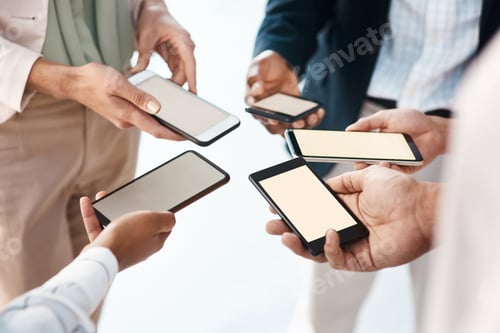 Preview: Shot of a group of unrecognisable businesspeople using their smartphones together
