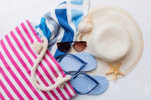 Preview: beach accessories flat lay top view on colored background Summer travel concept.