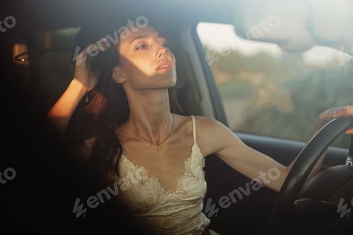 Preview: Beautiful smiling woman driving her car in the morning