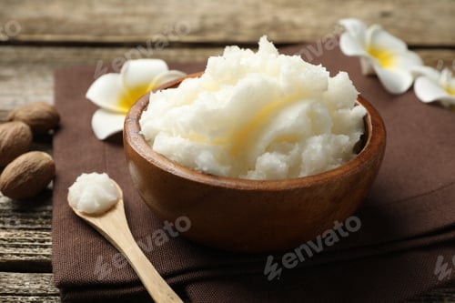 Preview: Natural shea butter and plumeria flowers on wooden table, closeup