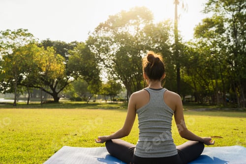 Preview: woman yoga outdoors keep calm and meditates while practicing yoga to explore the inner peace.