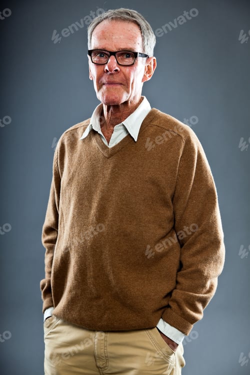 Preview: Expressive Good Looking Senior Man Wearing Glasses Against Grey Wall. Funny And Characteristic