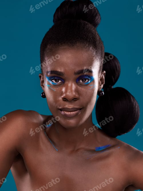 Preview: Studio portrait of a beautiful young woman posing against a turquoise background