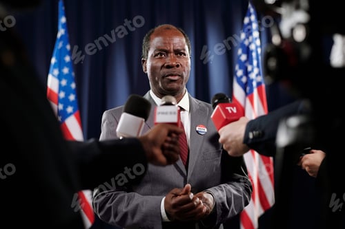 Preview: African American politician in formalwear asking questions of journalists