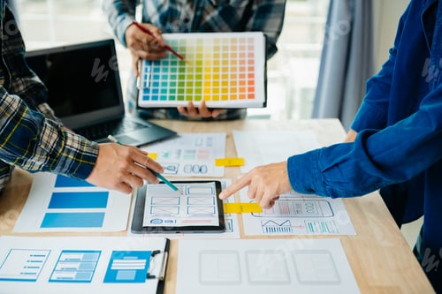 Preview: UX developer and ui designer brainstorming about mobile app interface wireframe design with customer