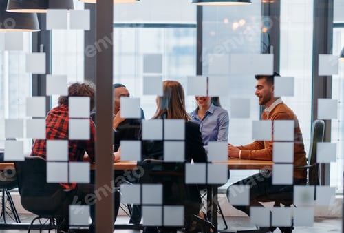 Preview: In a sleek glass office space, a team of business professionals engage in lively discussions and