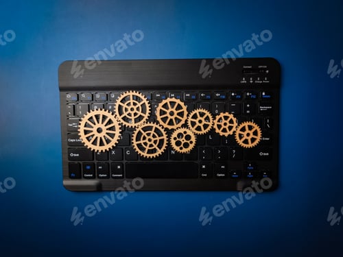 Preview: Top view black keyboard with wooden gear on a blue background.Business concept