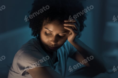 Preview: Sleepless african american woman sitting in bed at night