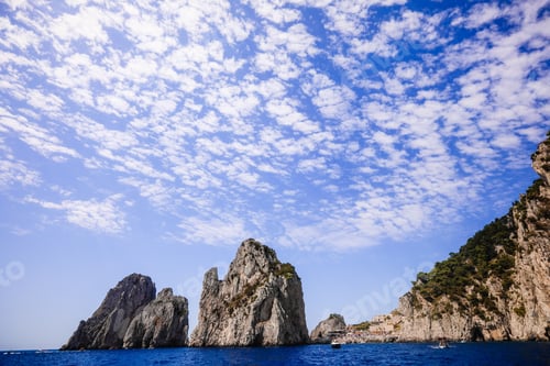 Preview: Majestic landscape featuring a tranquil body of water surrounded by large cliffs.