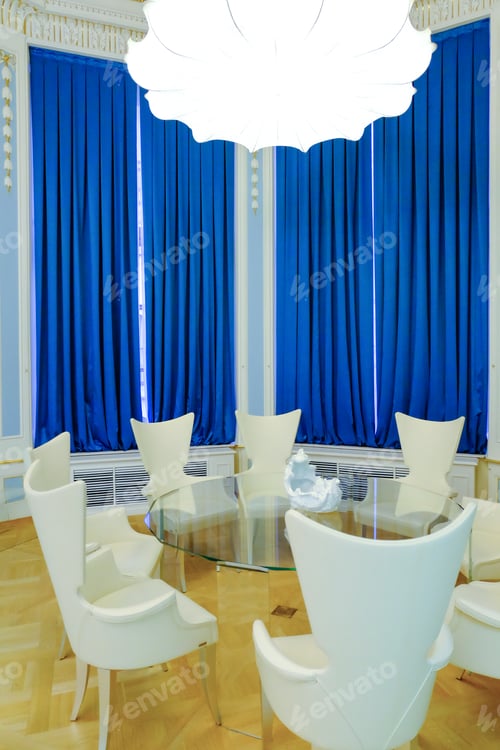 Preview: Glass Table And Chairs Against Blue Curtains. Round Table With Chairs In Round Room.