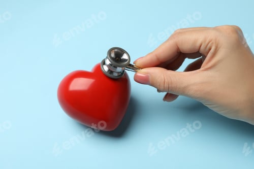 Preview: Female hand with stethoscope checking heart beat