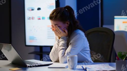Preview: Exhausted freelancer sleeping in front of laptop working