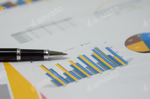 Preview: Business document reports graphics and charts and pen on paperwork