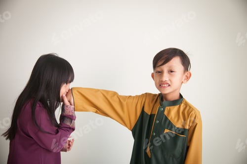 Preview: Brother and sister wearing beautiful baju kurung and jubah, a traditional malay costume
