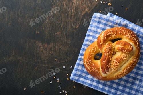 Preview: Bavarian pretzels and glass of lager beer. Oktoberfest food menu, traditional salted pretzels over o