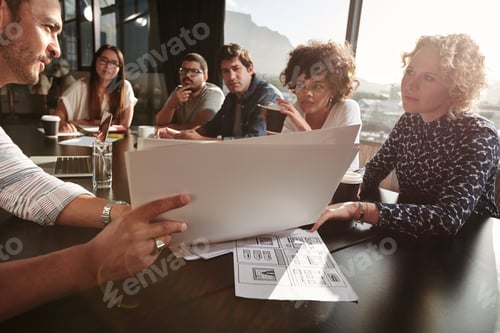 Preview: Team of young people going over paperwork
