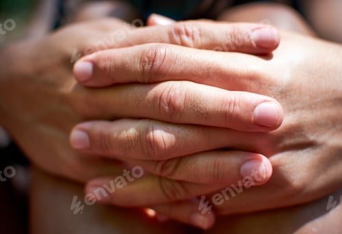 Preview: Selective focus closeup shot of a person's hands intertwined together