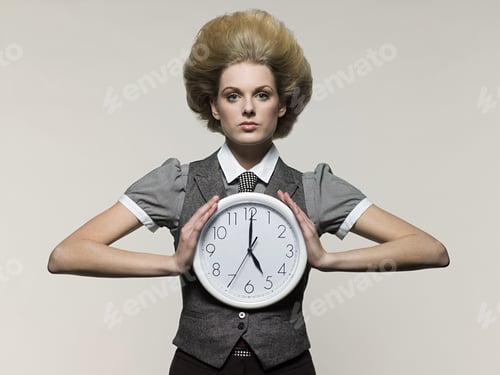 Preview: Businesswoman holding clock