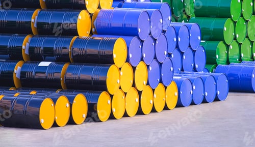 Preview: Piles of many various 200-litre oil drums stacked on the patio outside of industrial building