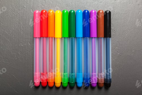 Preview: Colorful felt pens on the dark stone background top view