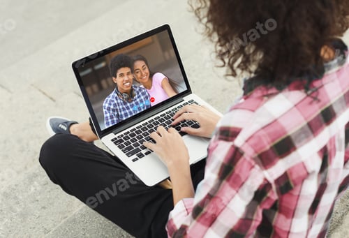 Preview: Young guy speaking to African American couple on webcam, using online video chat on laptop, outdoors