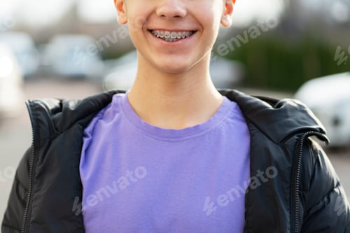 Preview: Portrait of smiling handsome boy with braces wearing stylish casual outfit, closeup