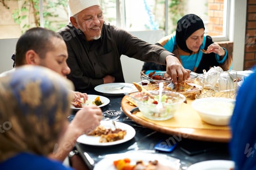 Preview: Food brings family together. Shot of a muslim family eating together.