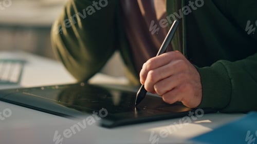 Preview: Closeup designer hand drawing tablet table. Busy artist talk phone working pad