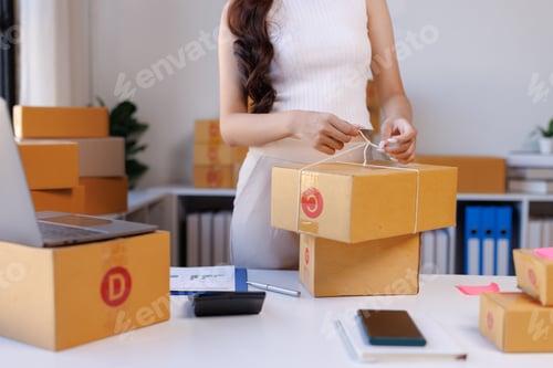 Preview: Woman preparing shipping packages for online store orders