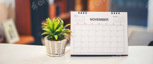 Preview: Desktop calendar and cactus placed on student wooden desk in living room.