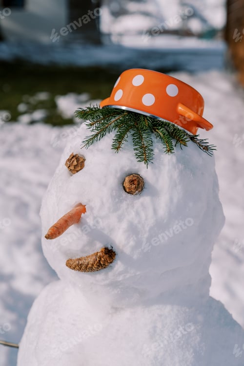 Preview: Smiling snowman in a saucepan hat stands in the courtyard