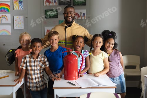Preview: African american young male teacher and multiracial elementary students with fire extinguisher