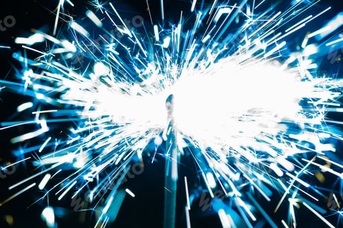 Preview: Close-up of blue sparkles of a burning fire