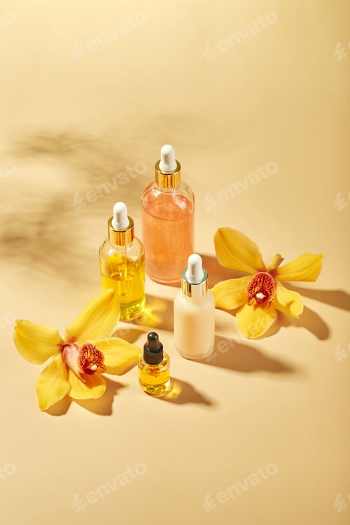 Preview: Cosmetic care products in glass bottles with orchid flowers - serums, cream, gel, oils. Concept for