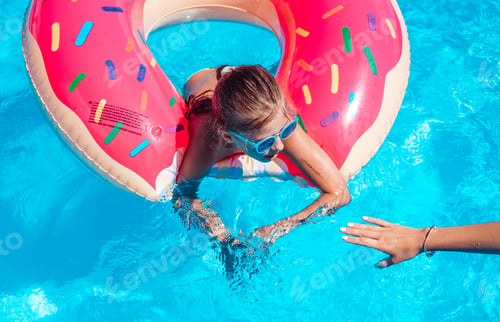 Preview: Girl on inflatable ring in swimming pool