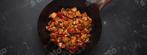 Preview: Traditional Chinese dish kung pao chicken in wok pan on dark background top view