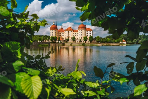 Preview: Castle Moritzburg in Saxony near Dresden. Framed by spring lush foliage leaves in foreground with