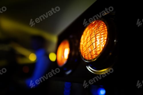 Preview: Yellow lights on stage of music band.