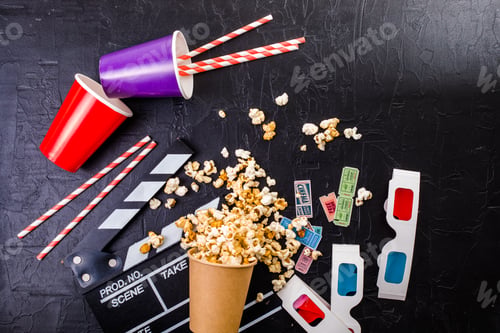 Preview: Movie tickets, soda drink plastic straws and popcorn . Home theatre movie or series night concept.