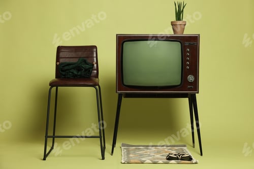 Preview: Retro TV set and other used stuff on olive background