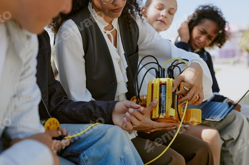Preview: Unrecognizable Teacher Showing Robots Details