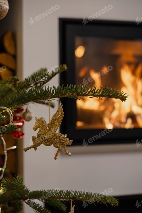 Preview: Glittery Pegasus Ornament Hanging on Christmas Tree with Cozy Fireplace Background