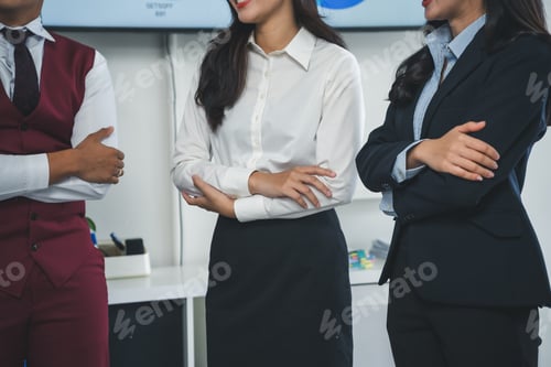 Preview: Confident business team standing with arms crossed in office meeting