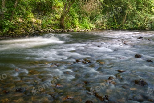 Preview: A river crosses a stony Riverbed