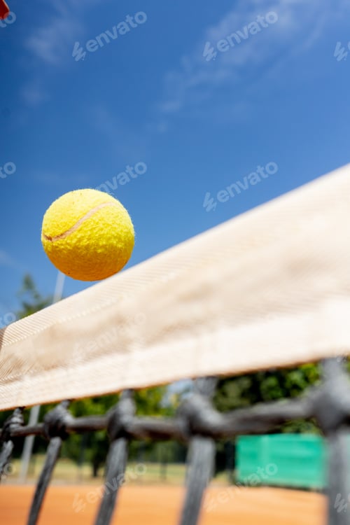 Preview: close-up of professional tennis field stretched net flight yellow tennis ball to opponent's field