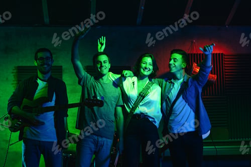Preview: Musicians In Stage With Colorful Lights Performing In A Live Concert