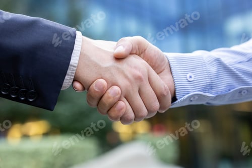 Preview: Business people shaking hands confirming agreement or partnership